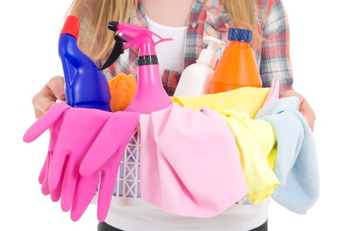 Local cleaner working in a Stockwell flat kitchen and living area